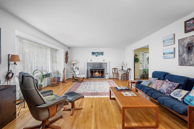 living room featuring hardwood / wood-style floors and a tile fireplace