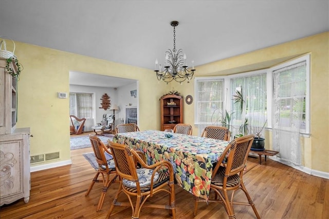 dining space featuring a chandelier and light hardwood / wood-style flooring