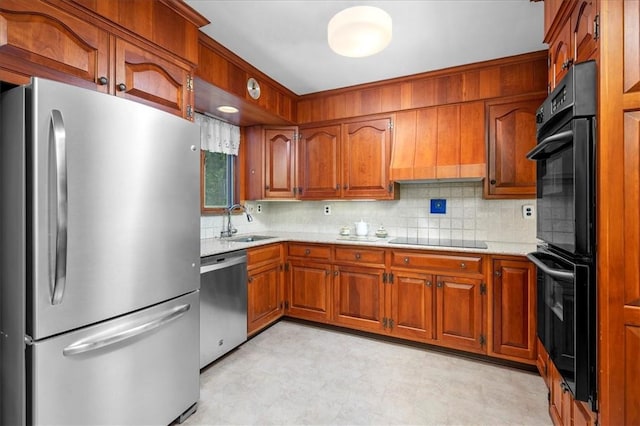 kitchen featuring black appliances, decorative backsplash, and sink