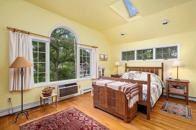 bedroom featuring multiple windows, lofted ceiling with skylight, light hardwood / wood-style flooring, and a baseboard radiator