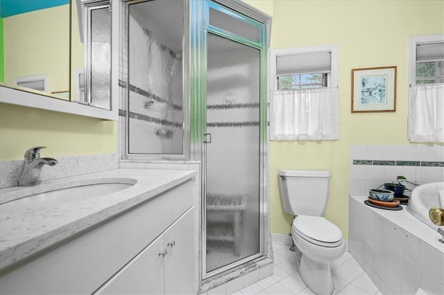 full bathroom featuring tile patterned floors, vanity, independent shower and bath, and toilet