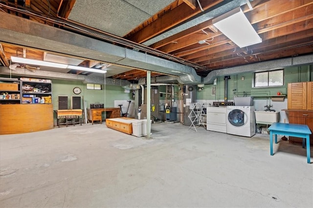 basement featuring washer and clothes dryer and sink