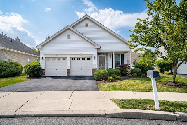 view of front of house featuring a front yard and a garage