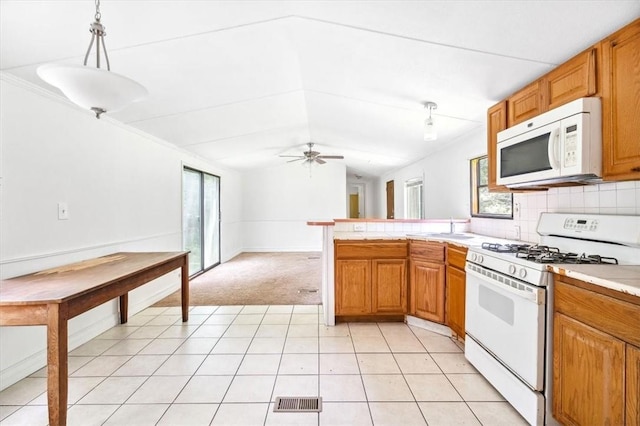 kitchen featuring white appliances, ceiling fan, pendant lighting, light tile patterned floors, and lofted ceiling