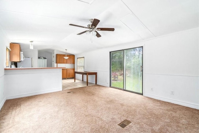 unfurnished living room featuring light colored carpet, ceiling fan, and lofted ceiling