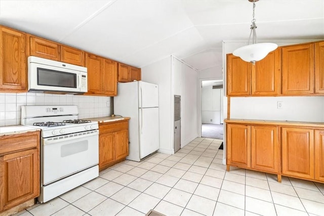 kitchen with lofted ceiling, white appliances, hanging light fixtures, decorative backsplash, and light tile patterned floors