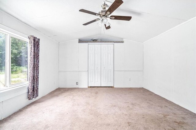 interior space featuring carpet flooring, ceiling fan, and lofted ceiling