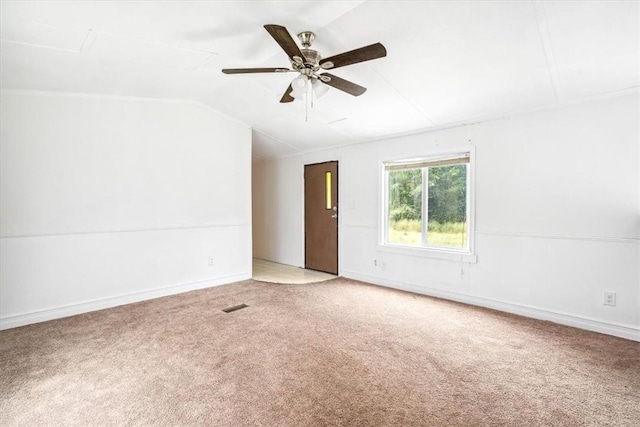 carpeted spare room with ceiling fan and lofted ceiling