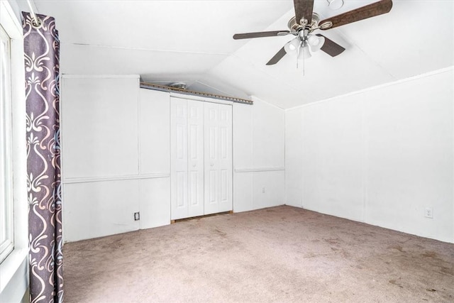 additional living space with carpet, ceiling fan, and vaulted ceiling