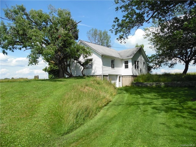 view of side of home with a lawn