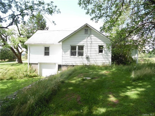 rear view of property with a lawn