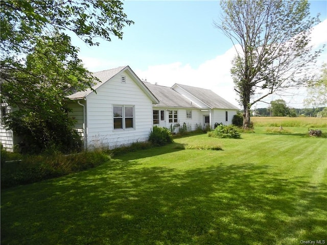 rear view of house with a lawn