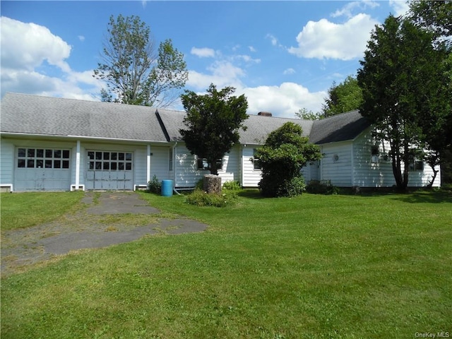 single story home with a front yard and a garage