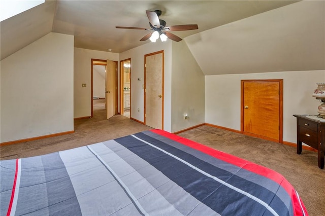 unfurnished bedroom featuring carpet floors, vaulted ceiling, and ceiling fan