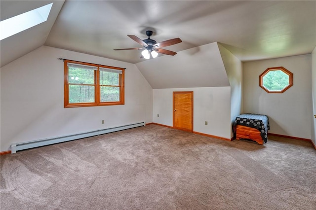 bonus room with light carpet, a baseboard radiator, lofted ceiling with skylight, and ceiling fan