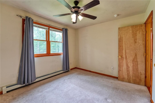 unfurnished room with light carpet, a baseboard radiator, and ceiling fan