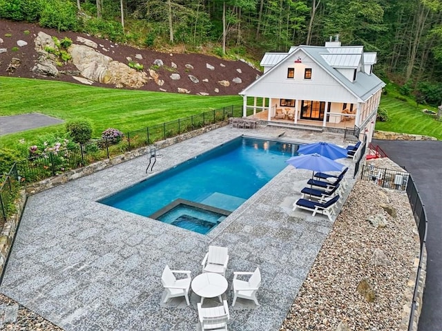 25 Red Oak Ln, Garrison, NY 10524 - view of pool featuring a storage structure, an outdoor structure, a patio, a pool with connected hot tub, and a wooded view