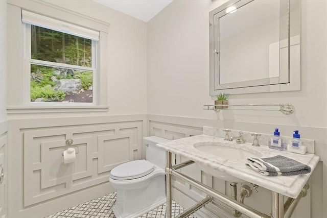 bathroom featuring sink, tile patterned flooring, and toilet