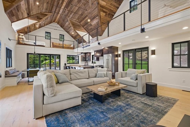 living room featuring light hardwood / wood-style floors, wood ceiling, and high vaulted ceiling