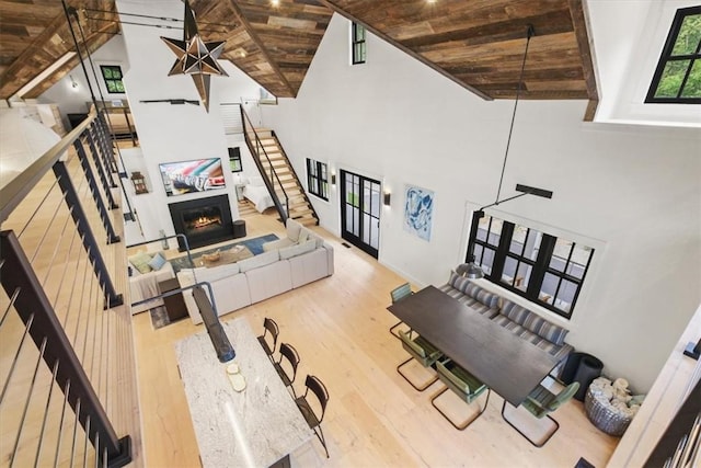 living room featuring hardwood / wood-style floors, wooden ceiling, beamed ceiling, and high vaulted ceiling