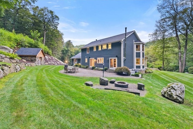 25 Red Oak Ln, Garrison, NY 10524 - back of property with an outdoor fire pit, a patio area, and a yard