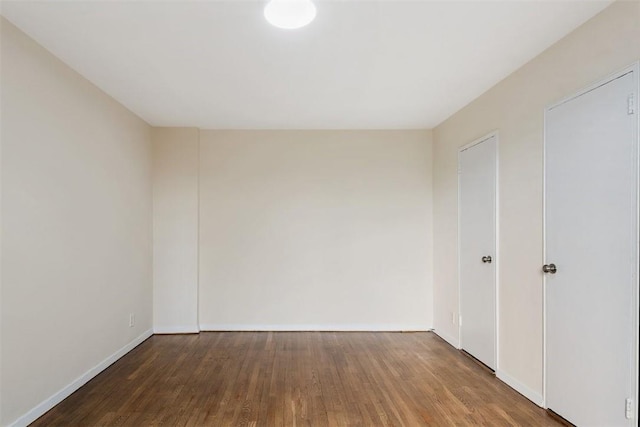 unfurnished room with wood-type flooring