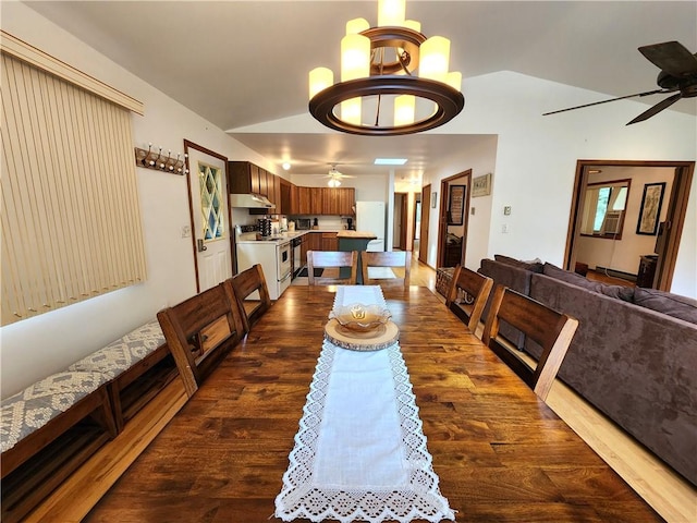 dining room with dark hardwood / wood-style floors, ceiling fan, and vaulted ceiling