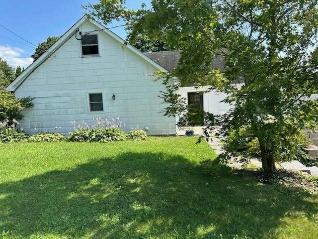 view of side of home featuring a yard