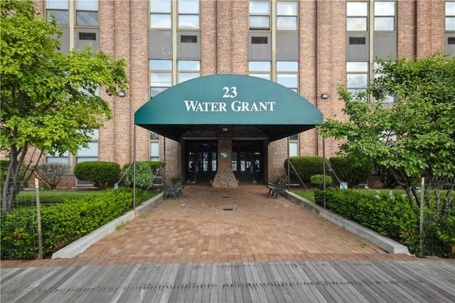 entrance to property featuring brick siding