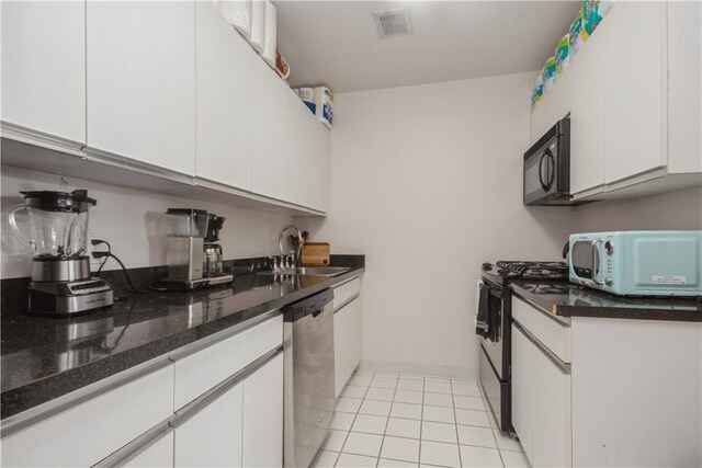 kitchen featuring black appliances, white cabinets, and a sink