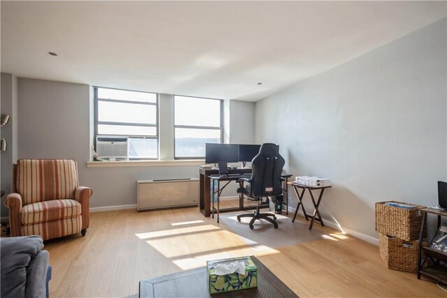 office space with wood finished floors and baseboards