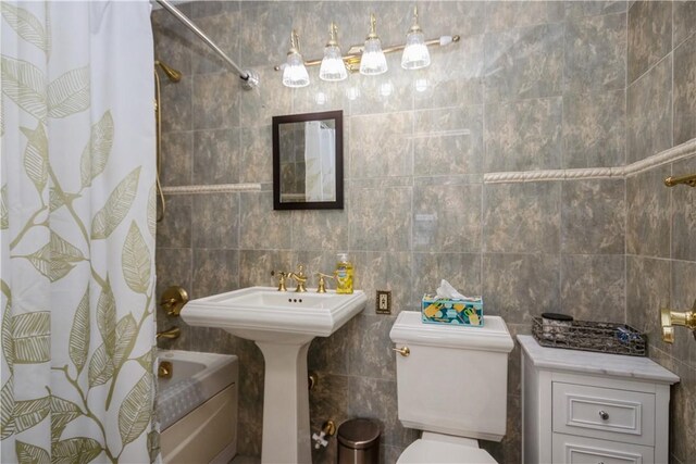 full bath featuring shower / bathtub combination with curtain, tile walls, and toilet