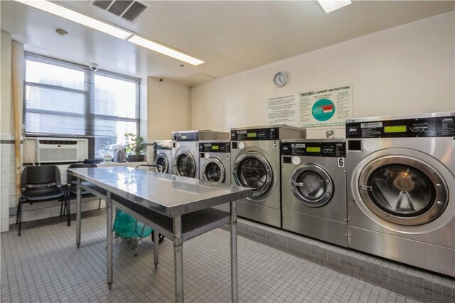 community laundry room featuring visible vents, cooling unit, and tile patterned floors