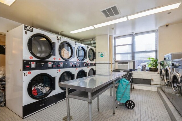 shared laundry area with visible vents, stacked washer / drying machine, and independent washer and dryer