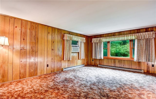 carpeted empty room with baseboard heating and wooden walls