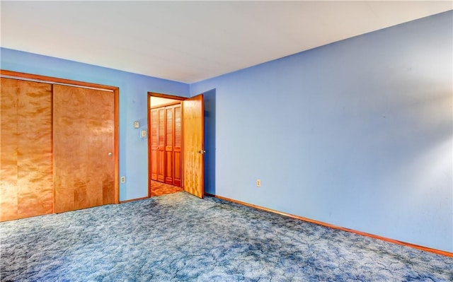 unfurnished bedroom with a closet and carpet floors