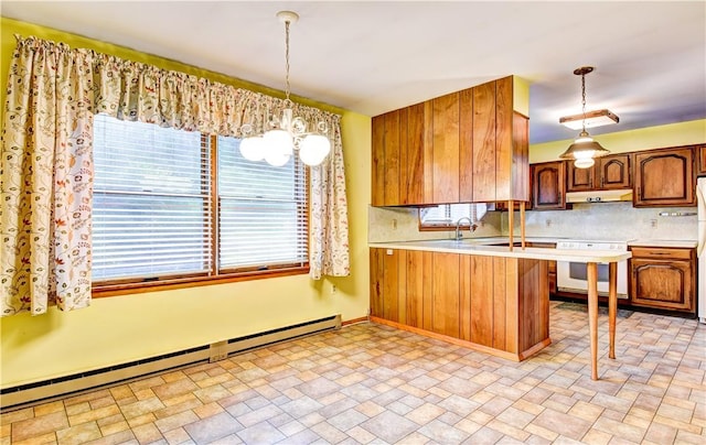 kitchen featuring pendant lighting, backsplash, kitchen peninsula, and baseboard heating