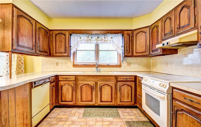 kitchen featuring decorative backsplash, plenty of natural light, white appliances, and sink