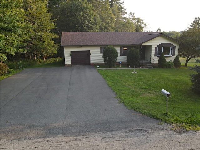 single story home with a garage and a front lawn