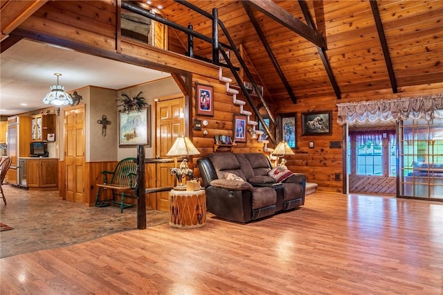 living room with vaulted ceiling with beams, hardwood / wood-style floors, and wood ceiling