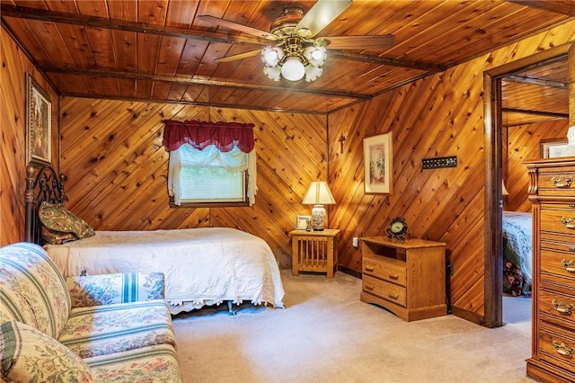 carpeted bedroom featuring beam ceiling, wooden ceiling, and wood walls