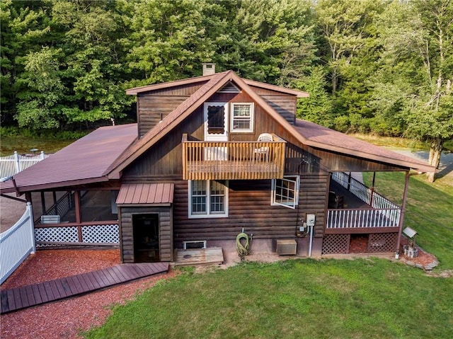 back of house with a yard, central air condition unit, and a sunroom