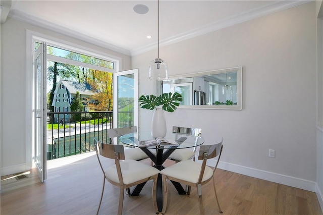 dining room featuring hardwood / wood-style flooring and ornamental molding