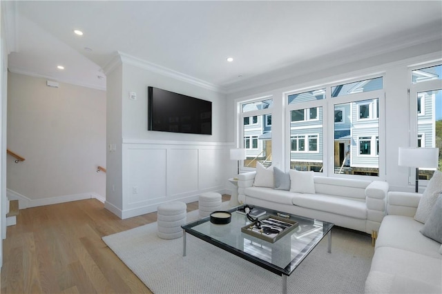 living room featuring light hardwood / wood-style flooring and crown molding