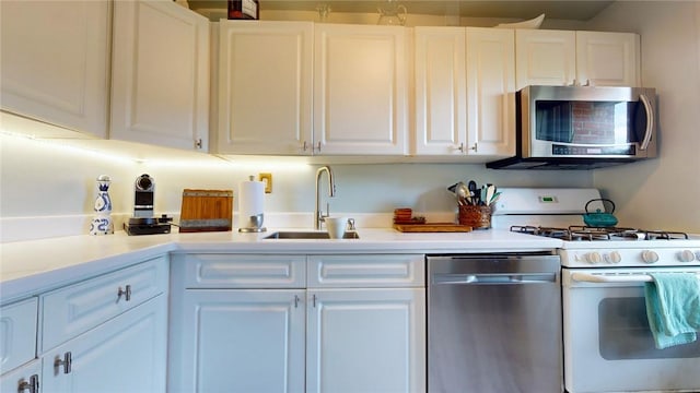 kitchen with sink, white cabinetry, and stainless steel appliances