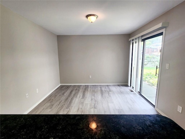 spare room featuring light wood-type flooring