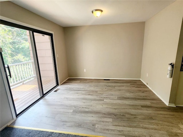 unfurnished room with hardwood / wood-style floors