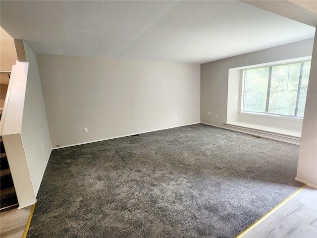 unfurnished living room featuring carpet