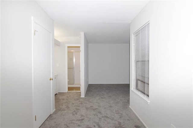 hall with light colored carpet