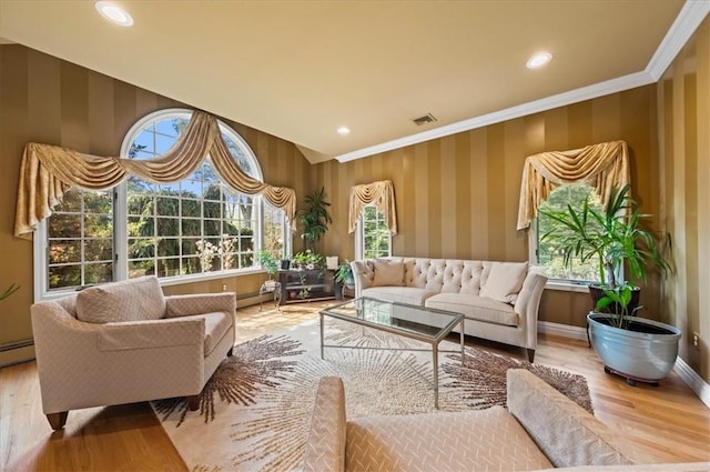 sitting room featuring hardwood / wood-style flooring, a wealth of natural light, and ornamental molding